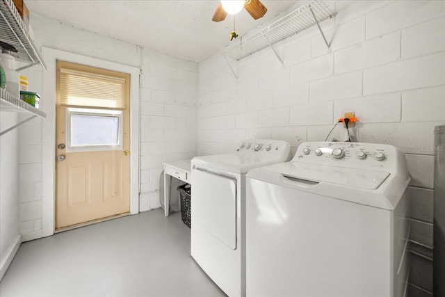 clothes washing area with laundry area, concrete block wall, washing machine and dryer, and ceiling fan