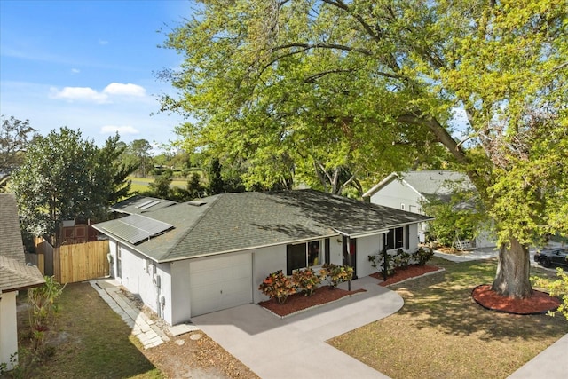 ranch-style home with stucco siding, driveway, fence, roof with shingles, and an attached garage