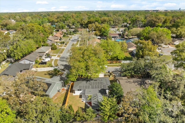 birds eye view of property with a wooded view and a residential view