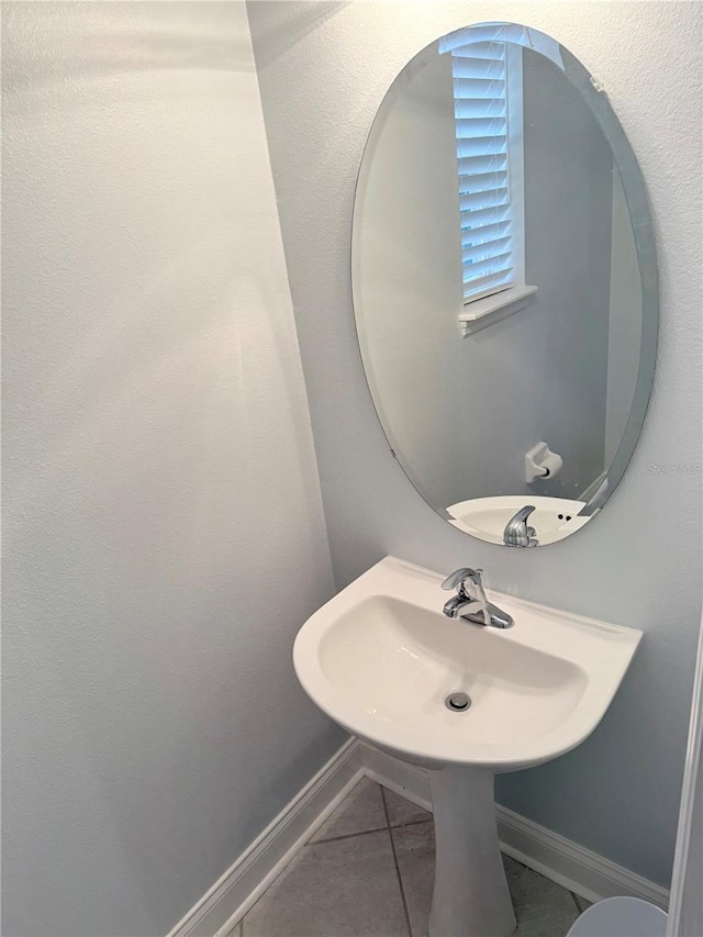 bathroom with tile patterned floors and baseboards