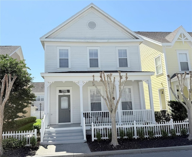 greek revival inspired property with fence and covered porch