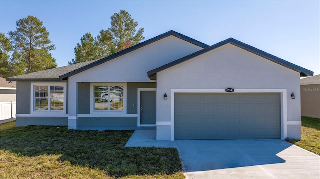 ranch-style house featuring concrete driveway, an attached garage, and stucco siding