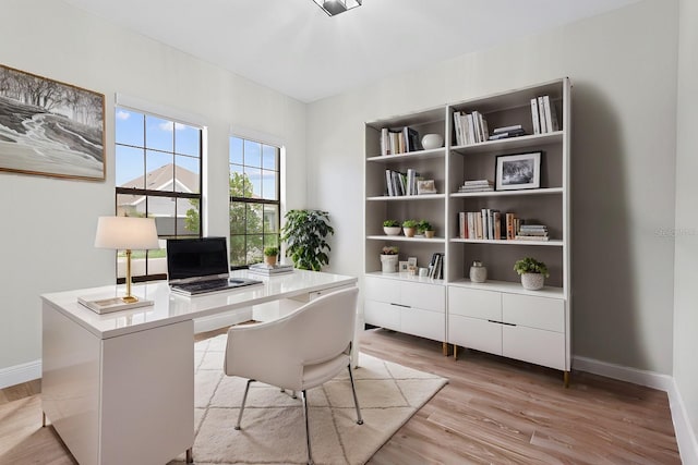 office area with light wood-type flooring and baseboards