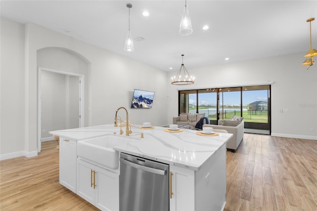 kitchen featuring recessed lighting, open floor plan, a sink, light wood-type flooring, and dishwasher