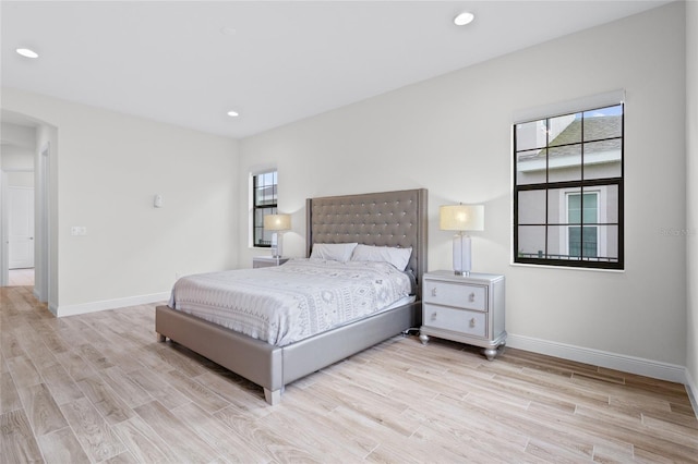 bedroom with recessed lighting, light wood-type flooring, and baseboards