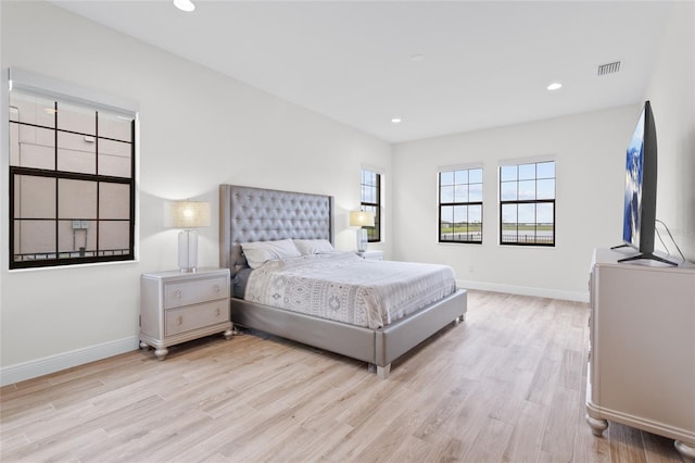 bedroom with light wood-type flooring, visible vents, baseboards, and recessed lighting