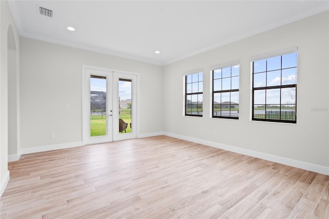 spare room with light wood-style floors, visible vents, baseboards, and french doors