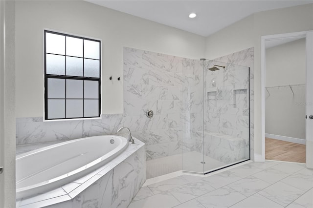 full bath featuring marble finish floor, a marble finish shower, recessed lighting, a spacious closet, and a bath