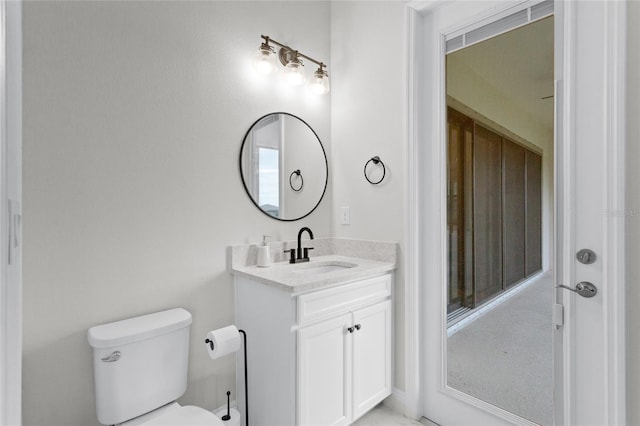 half bath featuring toilet and vanity