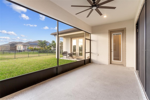 unfurnished sunroom featuring french doors and ceiling fan