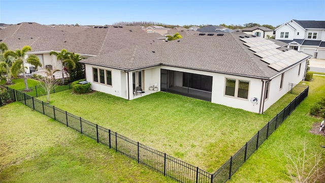 back of house featuring a yard, roof with shingles, a fenced backyard, and stucco siding