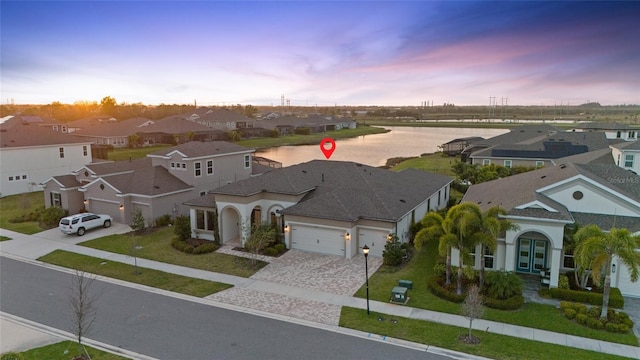 aerial view at dusk featuring a residential view