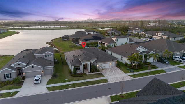 drone / aerial view featuring a water view and a residential view