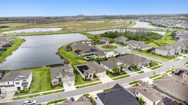 drone / aerial view with a residential view and a water view