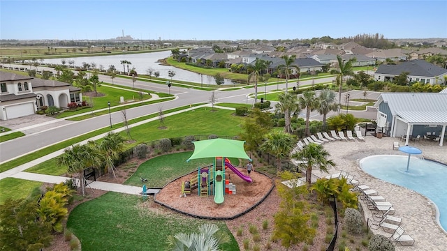 birds eye view of property with a water view and a residential view