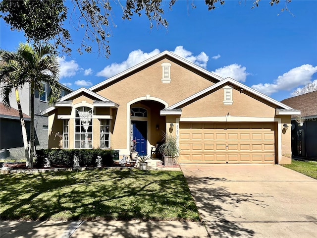 ranch-style home with a garage, concrete driveway, a front lawn, and stucco siding