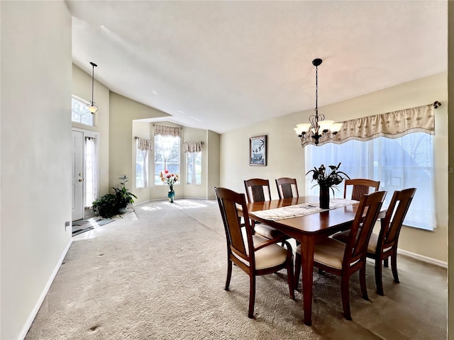 carpeted dining room featuring high vaulted ceiling, baseboards, and a chandelier