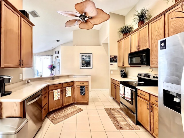 kitchen featuring light tile patterned flooring, stainless steel appliances, a peninsula, a sink, and light countertops