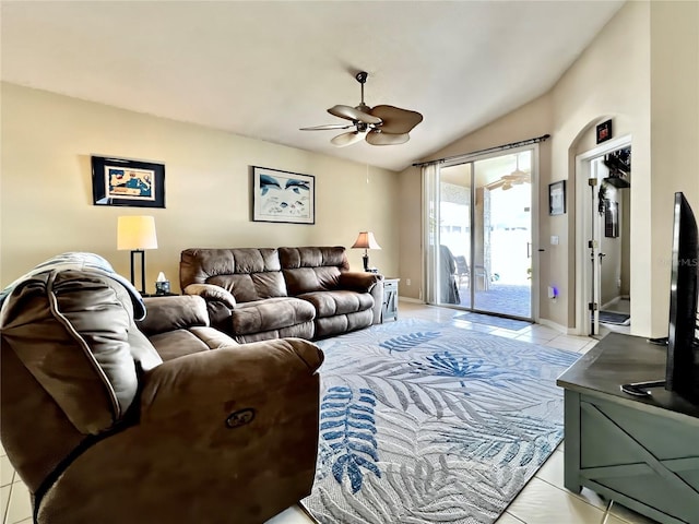 living area featuring lofted ceiling, ceiling fan, baseboards, and light tile patterned flooring