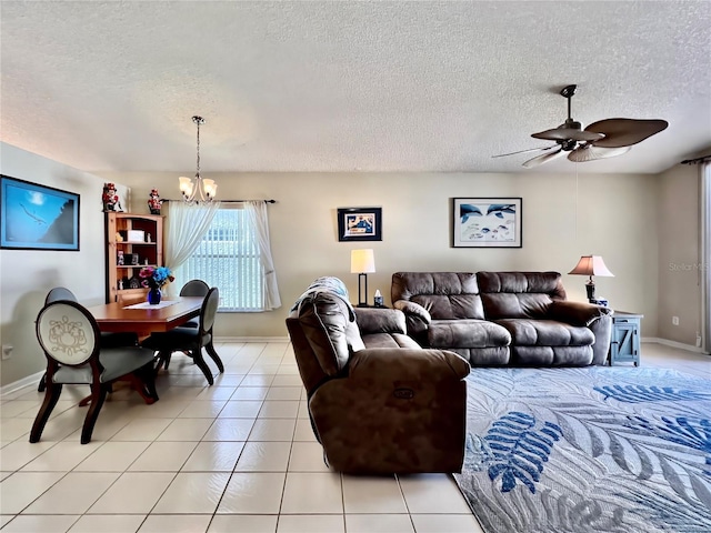 living room with light tile patterned floors, a textured ceiling, and ceiling fan with notable chandelier