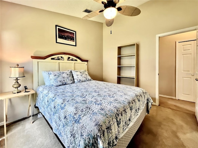 carpeted bedroom featuring visible vents, ceiling fan, and baseboards