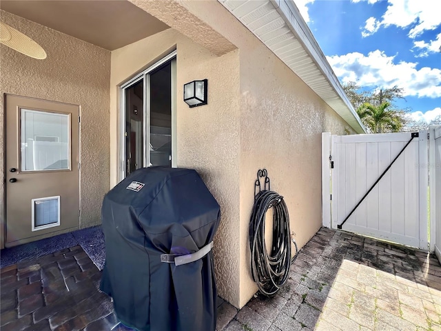 view of patio / terrace with a gate, fence, and area for grilling