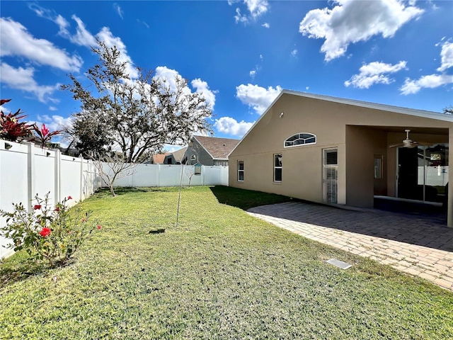 view of yard with ceiling fan, a patio, and a fenced backyard