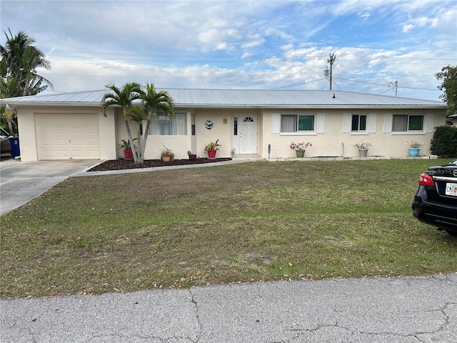 ranch-style home with stucco siding, concrete driveway, an attached garage, a front yard, and metal roof