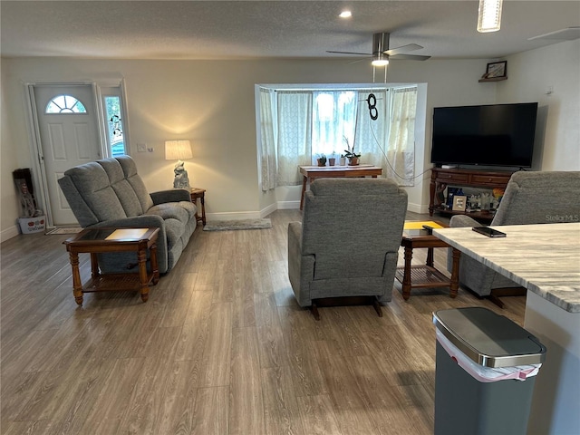 living area featuring a textured ceiling, plenty of natural light, and wood finished floors