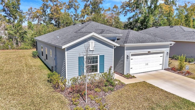 view of front of property with a garage, a front yard, roof with shingles, and driveway