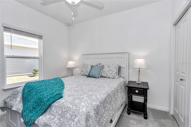 carpeted bedroom with a closet, a ceiling fan, and baseboards