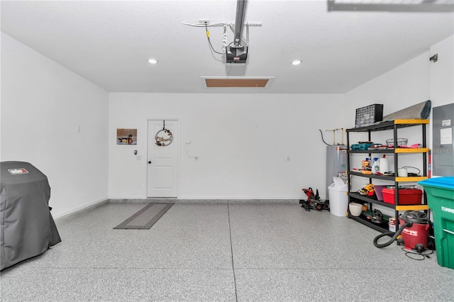 garage featuring recessed lighting, water heater, baseboards, and a garage door opener