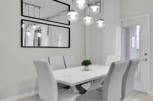 dining room with tile patterned flooring and baseboards