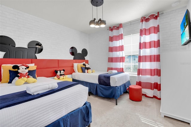 carpeted bedroom featuring brick wall