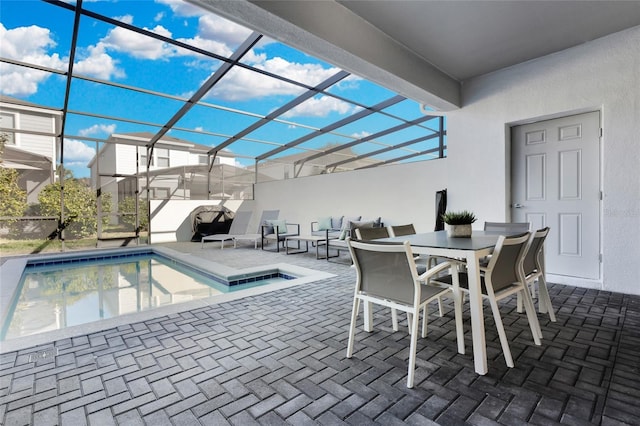 outdoor pool featuring glass enclosure and a patio