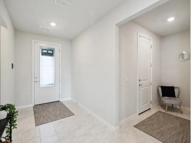 foyer featuring recessed lighting, visible vents, and baseboards