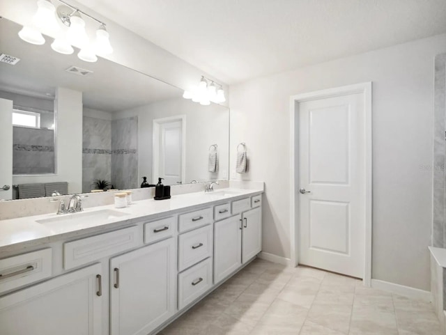 full bathroom featuring visible vents, a sink, baseboards, and double vanity