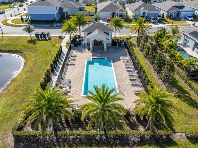 view of swimming pool with a residential view and fence