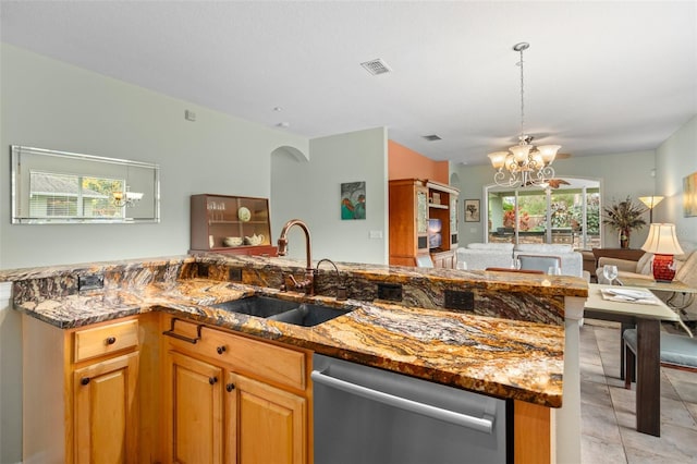 kitchen featuring stone counters, visible vents, stainless steel dishwasher, open floor plan, and a sink