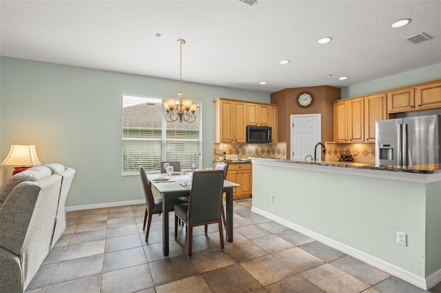 dining room featuring baseboards, visible vents, a chandelier, and recessed lighting