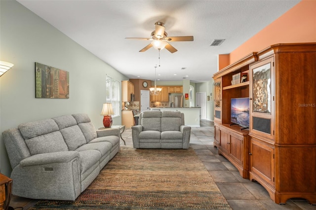 living room featuring visible vents and ceiling fan with notable chandelier