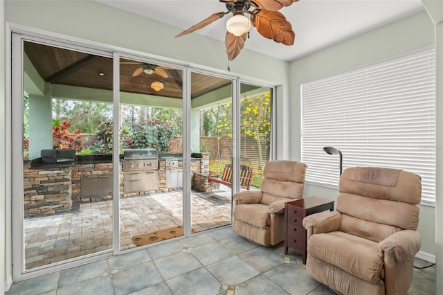 sunroom / solarium featuring ceiling fan