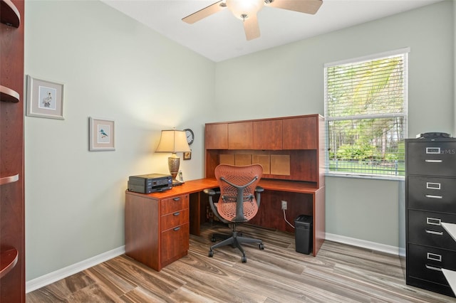 office area with a ceiling fan, baseboards, and light wood finished floors