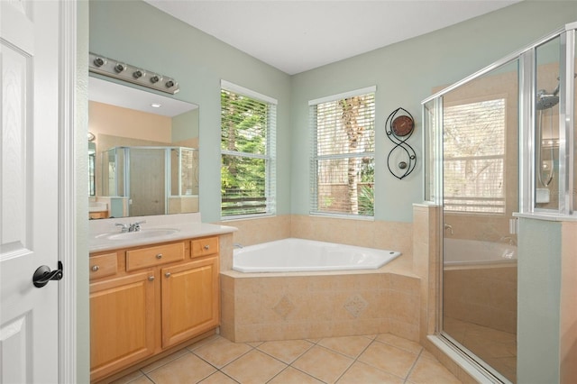 bathroom featuring a bath, a stall shower, tile patterned flooring, and vanity