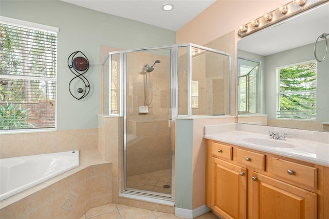 full bathroom with tile patterned flooring, a shower stall, vanity, and a bath