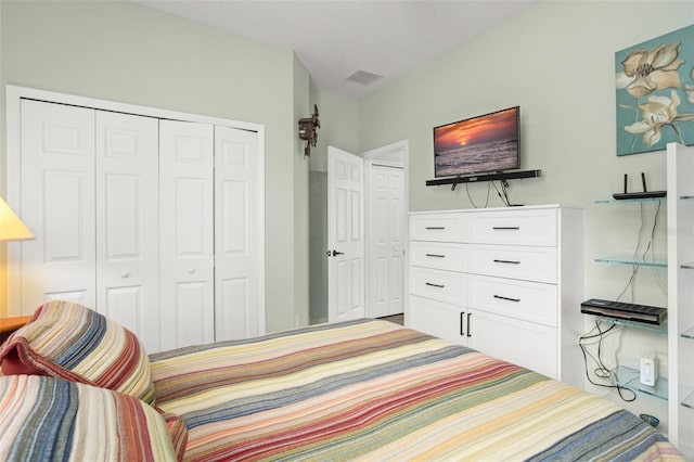 bedroom with a closet and visible vents