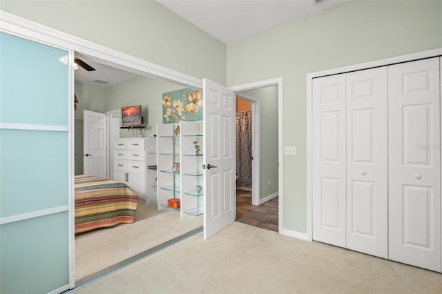 unfurnished bedroom featuring a ceiling fan, carpet, baseboards, and a closet