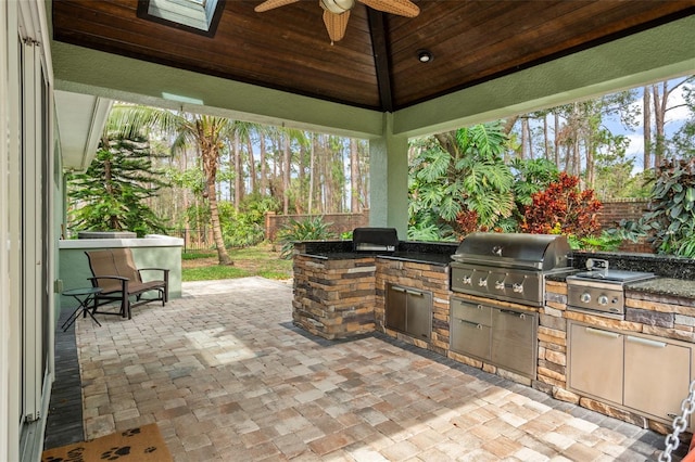 view of patio / terrace featuring a gazebo, area for grilling, a fenced backyard, and a ceiling fan