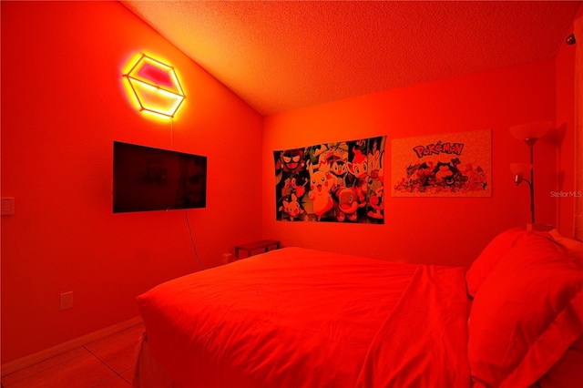 bedroom with lofted ceiling and a textured ceiling