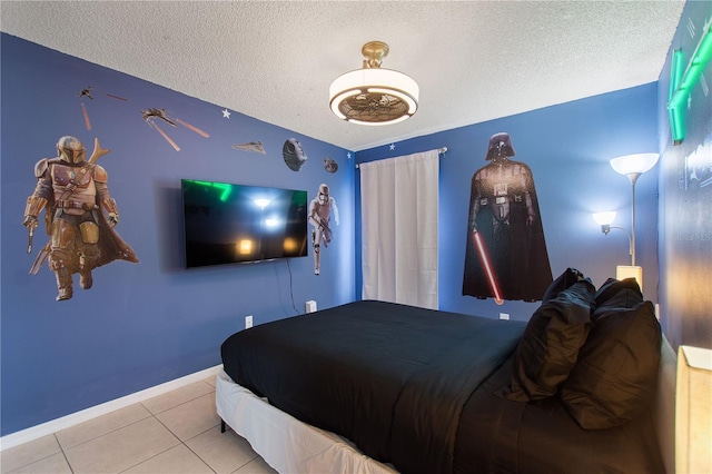 tiled bedroom with a textured ceiling and baseboards